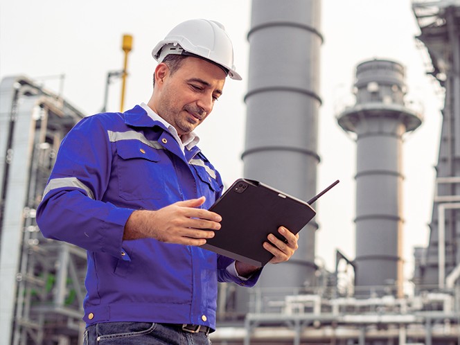 worker checking tablet at plant